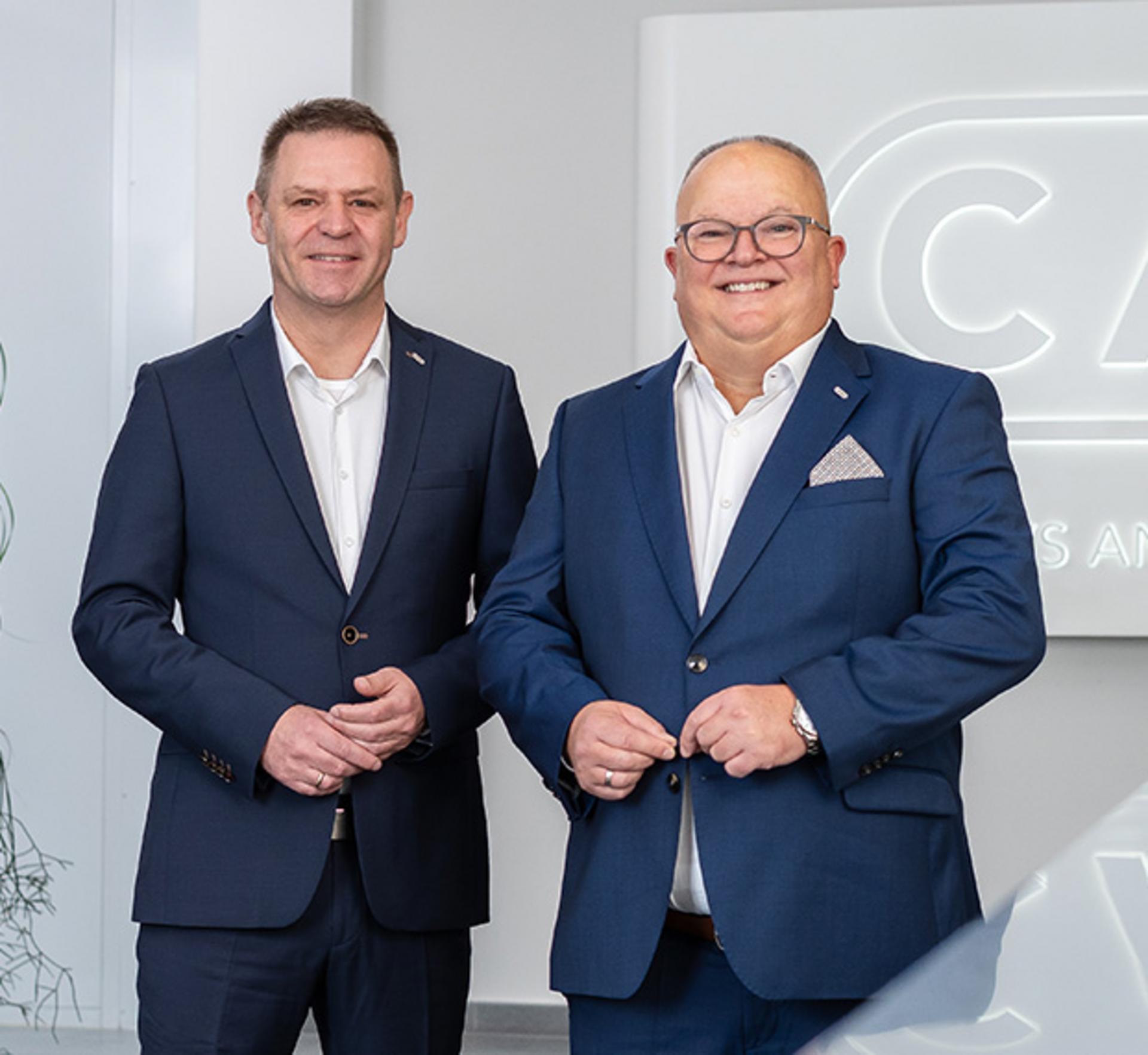 CEOS posing together in front of a neutral background